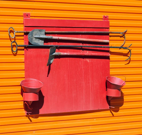 Escudo de bombeiro com ferramentas de extinção de incêndios — Fotografia de Stock