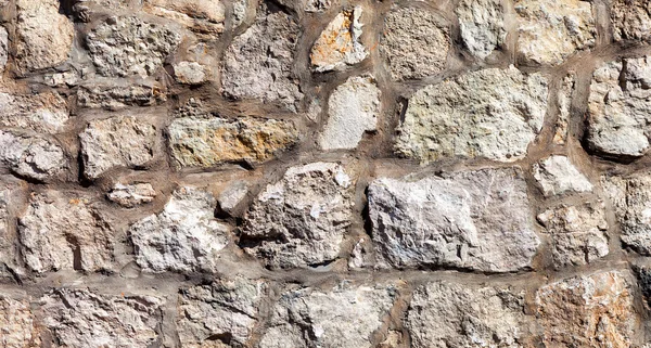 Фрагмент серой каменной стены в качестве фона — стоковое фото