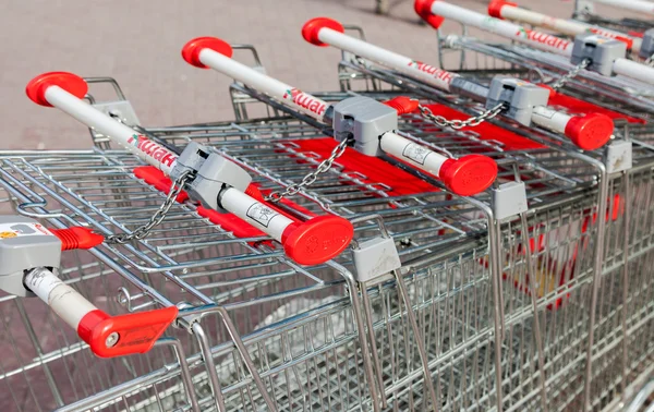 Shopping carts Auchan store. French distribution network Auchan — Stock Photo, Image