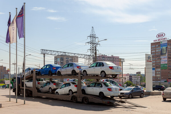 Truck brought new cars to car showroom Datsun in Samara, Russia