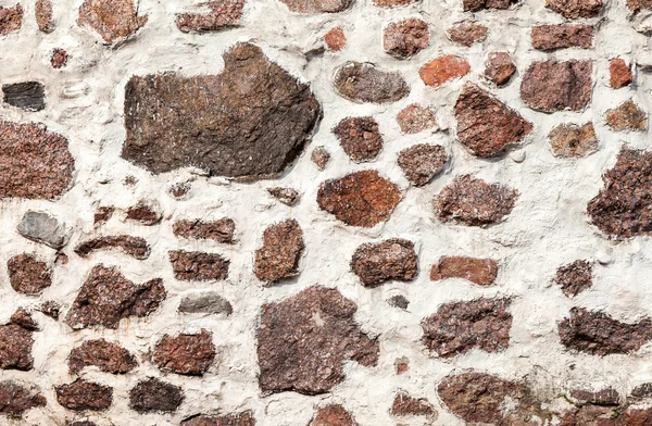 Fragment of a natural old stone wall as background — Stock Photo, Image