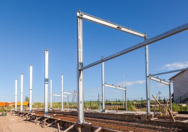 Erection of metal structures in summer sunny day clipart