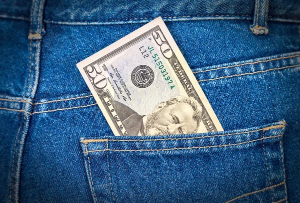 Fifty dollars bill sticking out of the blue jeans pocket — Stock Photo, Image