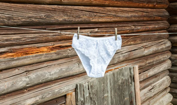 Ladies white lace panties hanging on the rope — Stock Photo, Image