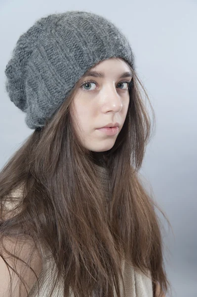 Young brunette girl in a knitted hat — Stock Photo, Image