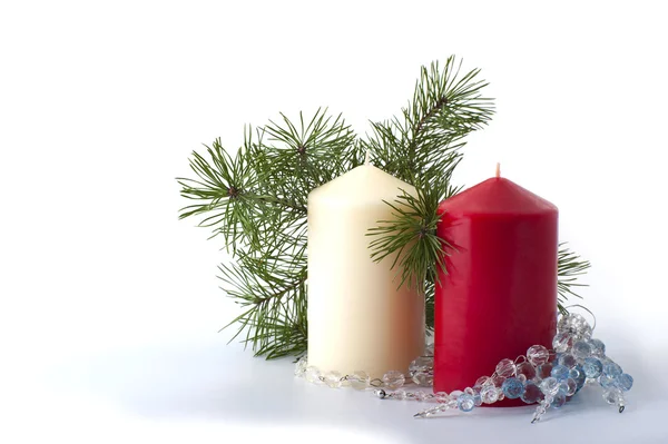 Two candles, Christmas tree branch and Christmas decorations — Stock Photo, Image