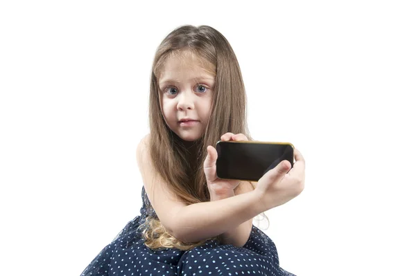 Portrait of a little girl with mobile phone in hand — Stock Photo, Image