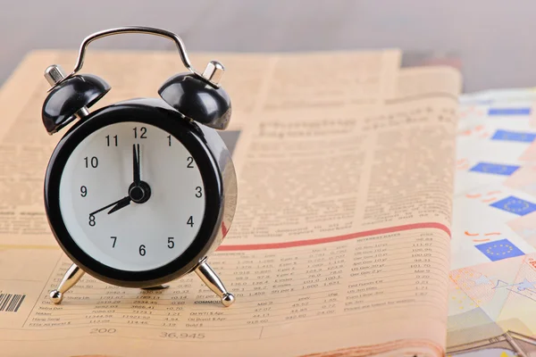 Close-up of clock, Euro banknotes and newspaper — Stock Photo, Image