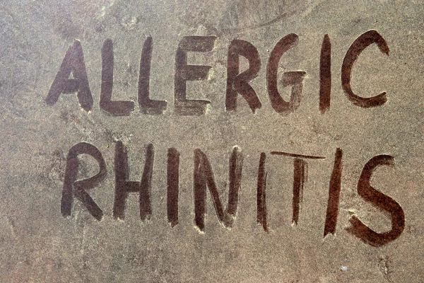 Allergic rhinitis text over yellow pollen grains on the background. — Stock Photo, Image