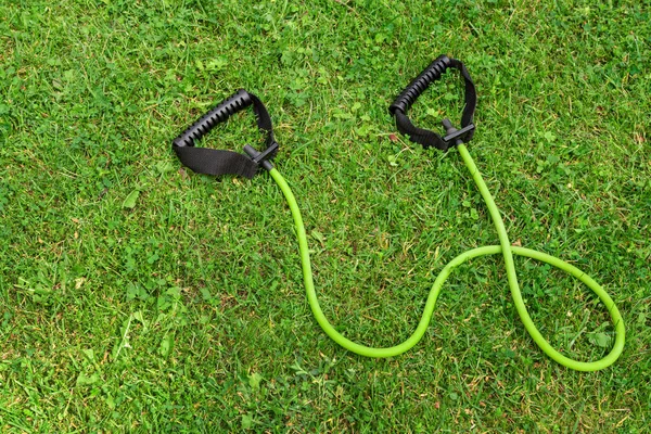 Fit tube on the green grass background — Stock Photo, Image