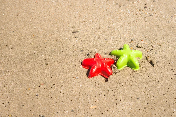 Starfish-shaped molds on the sand — Stock Photo, Image