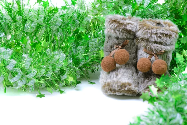 Green tinsel with snow boots decoration — Stock Photo, Image