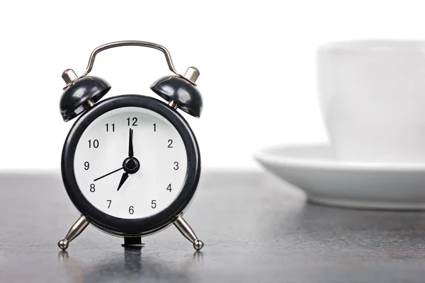 Alarm clock with cup of coffee — Stock Photo, Image