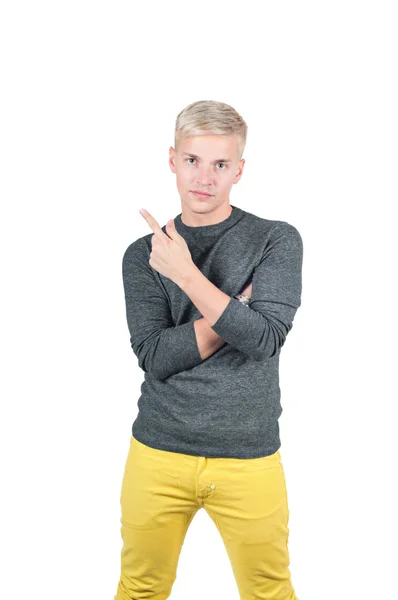 Young handsome guy showing somewhere with finger — Stock Photo, Image