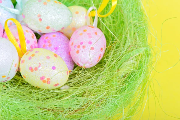 Easter eggs in green nest — Stock Photo, Image
