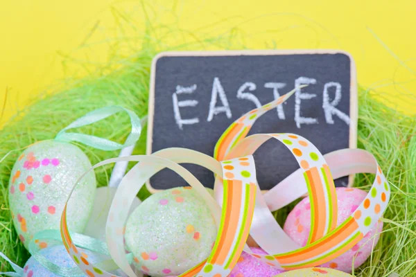 Easter ribbon with eggs and board — Stock Photo, Image