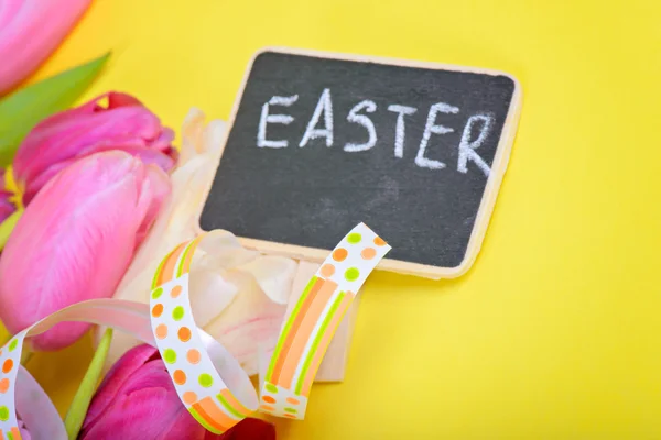 Easter ribbon, tulips and small chalkboard — Stock Photo, Image