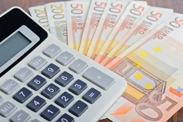 Calculator and banknotes on the table — Stock Photo, Image