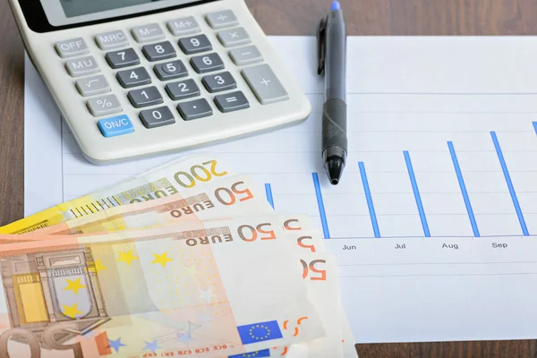 Calculator, graphyc and pen on the table — Stock Photo, Image