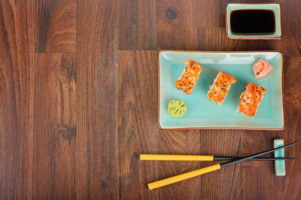 Sushi tekercs a fából készült asztal. Szemközti nézet. — Stock Fotó