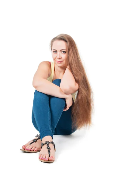 Positive young female sitting on the floor — Stock Photo, Image