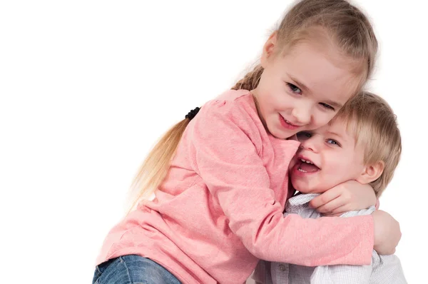 Brother and sister hugging in studio — Stock Photo, Image