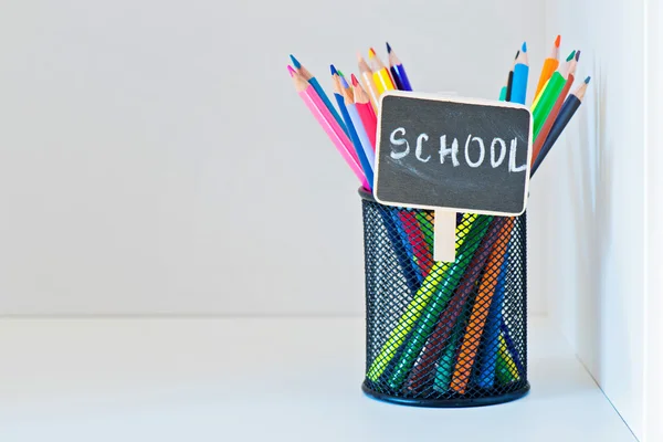 Pencils in a holder on the light-coloured shelf — Stock Photo, Image