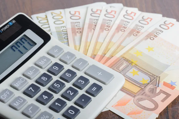 Calculator and banknotes on the table — Stock Photo, Image