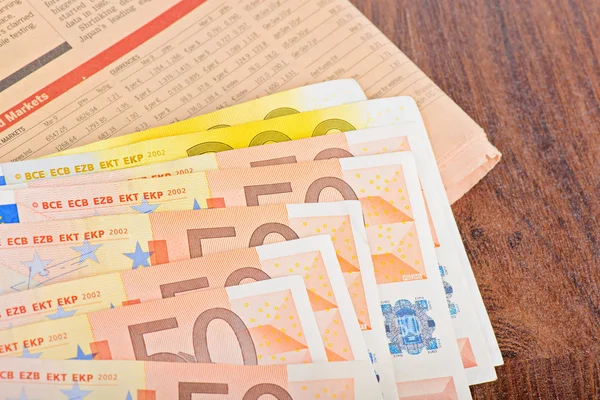 Close-up of Euro banknotes with newspaper — Stock Photo, Image