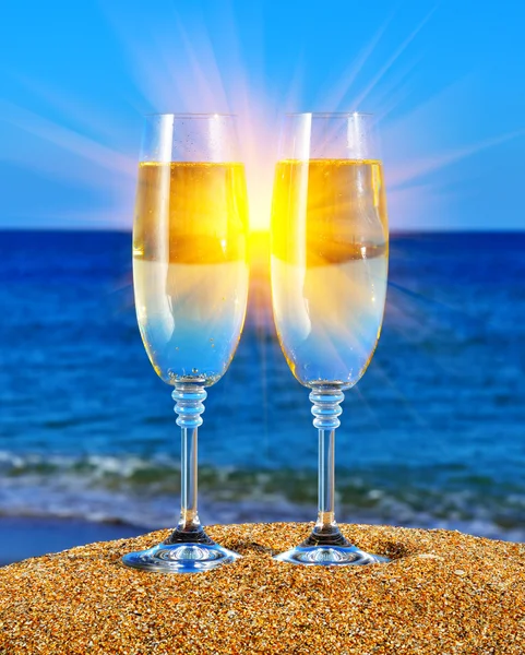 Glasses with champagne near the sea — Stock Photo, Image
