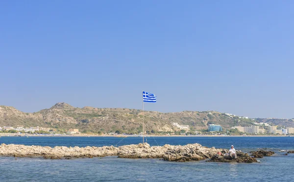 Island with a Greek flag. The resort of Faliraki. Rhodes Island.