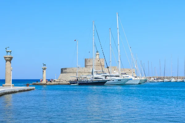 Antik staty av en hjort och en medeltida fyr på port o — Stockfoto