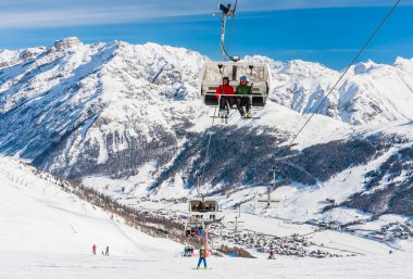 LIVIGNO, ITALY - JANUARY 28, 2015: Ski lift and ski slopes in the mountains of winter resort Livigno, Lombardi, January 28, 2015, Italy. Livigno is  developing ski resort in northern Italy