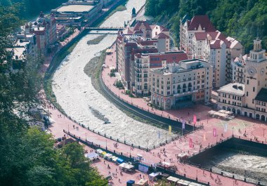 View of the embankment of the river Mzymta and central area ski resort Rosa Khutor. Sochi, Russia.