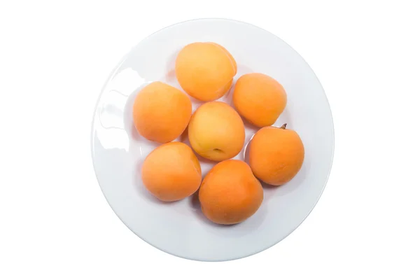 Yellow peach slices on plate isolated on white — Stock Photo, Image