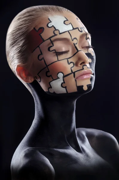 Puzzles painted on face — Zdjęcie stockowe