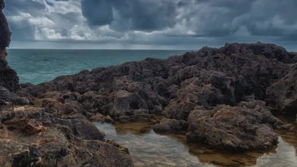 Detailed view of volcanic coastline with high cliffs and waves breaking over volcanic rocks, Portugal. — Stock Video