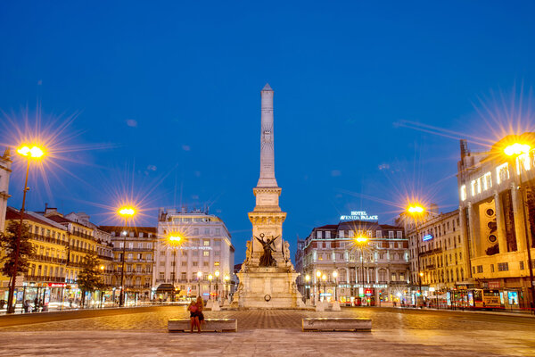 Romantic Lisbon street. Fountain at night in the center of the c