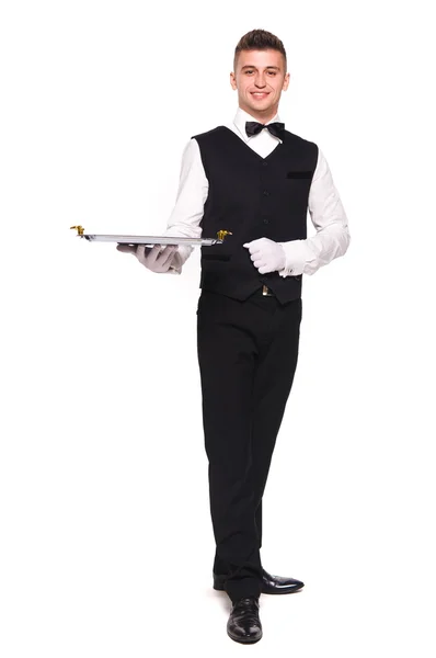 Young person in a suit holding an empty tray isolated on white b — Stock Photo, Image