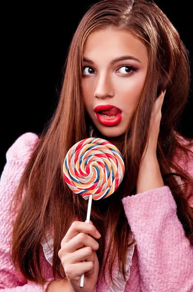 Young girl sucks sweet on stick — Stock Photo, Image