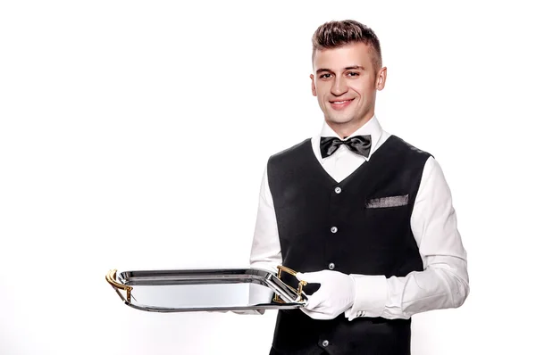 Portrait of young happy smiling waiter with on tray isolated on — Stock Photo, Image