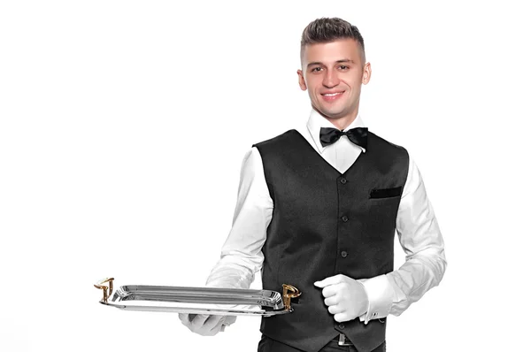 Portrait of young happy smiling waiter with on tray isolated on — Stock Photo, Image