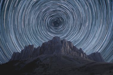 Star trails over the mountains. clipart