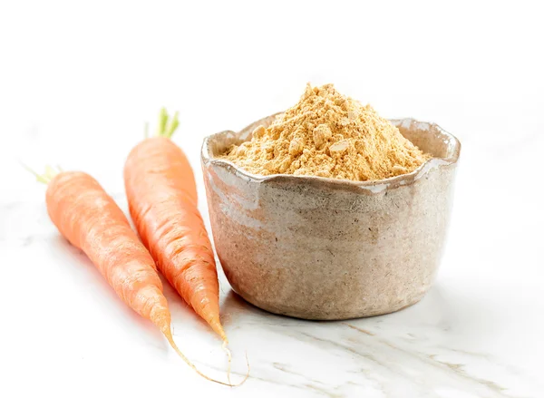 Bowl of dried carrot powder — Stock Photo, Image