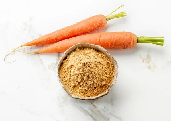 Bowl of dried carrot powder — Stock Photo, Image