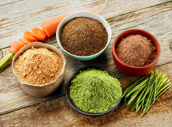 Bowls of various dried plant powders — Stock Photo, Image