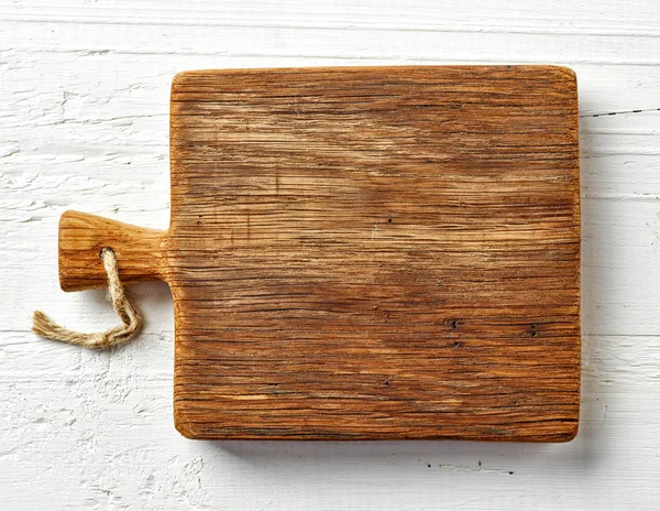 Cutting board on white wooden table