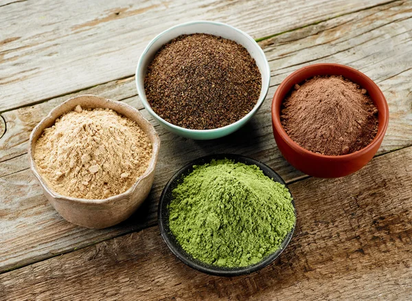 bowls of various dried plant powders