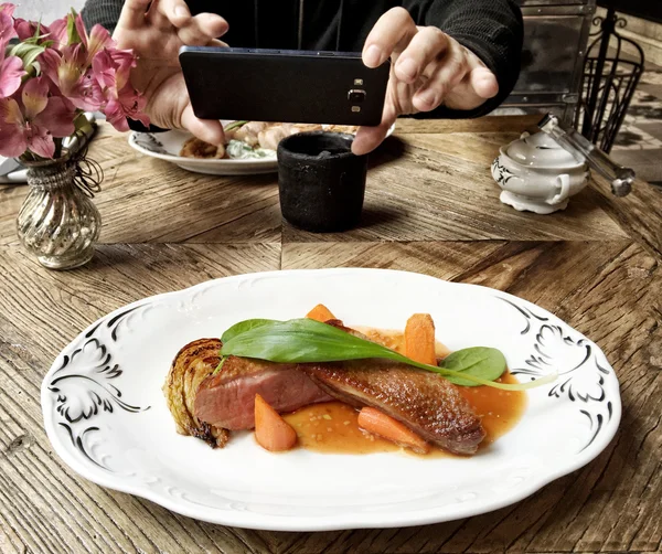 Taking photo of duck fillet portion with smart phone — Stock Photo, Image