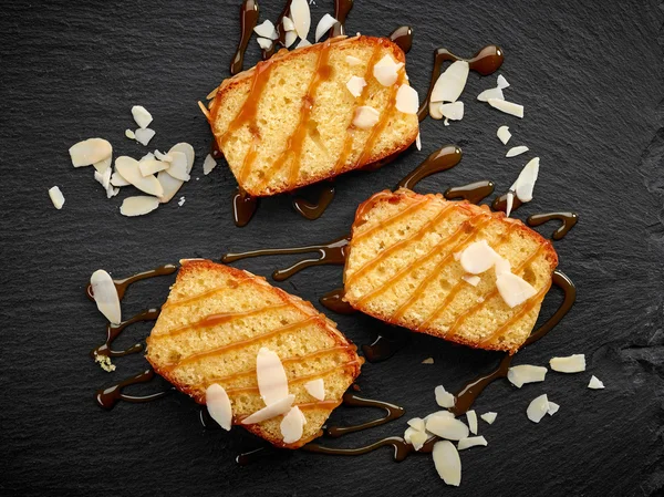 Biscuit cake slices with sweet caramel sauce — Stock Photo, Image